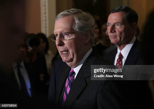 Senate Majority Leader Sen. Mitch McConnell speaks as Sen. John Barrasso listens during a briefing after the Senate Republican weekly policy luncheon...
