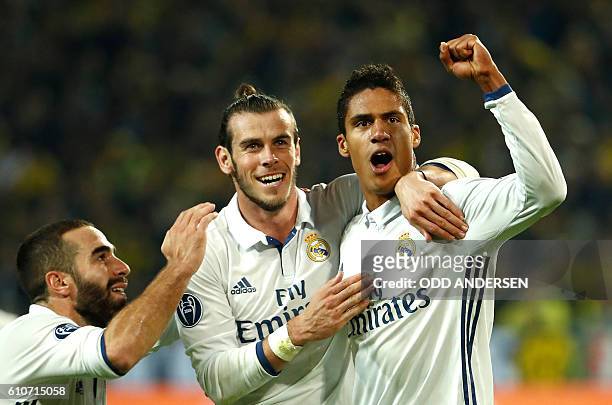 Real Madrid's French defender Raphael Varane reacts after scoring with Real Madrid's Welsh forward Gareth Bale during the UEFA Champions League first...