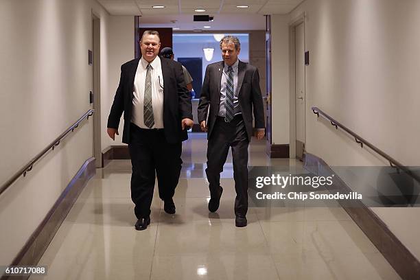 Sen. Jon Tester and Sen. Sherrod Brown leave a classified briefing they and other members of the Senate received about the investigation into...