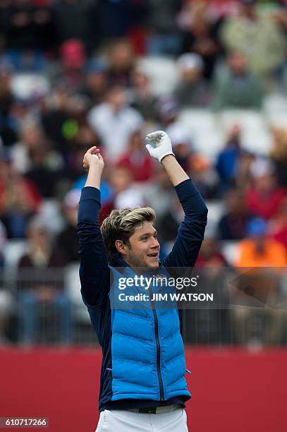 Irish singer-songwriter and guitarist Niall Horan, known as a member of the boy band One Direction, cheers with fans during a celebrity scramble...
