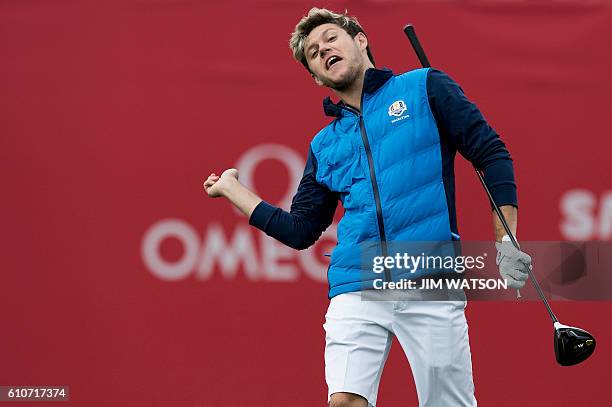Irish singer-songwriter and guitarist Niall Horan, known as a member of the boy band One Direction, throws something to fans during a celebrity...
