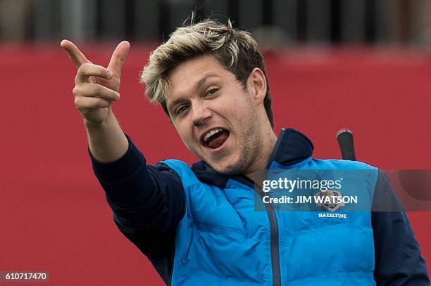 Irish singer-songwriter and guitarist Niall Horan, known as a member of the boy band One Direction, gestures during a celebrity scramble match ahead...