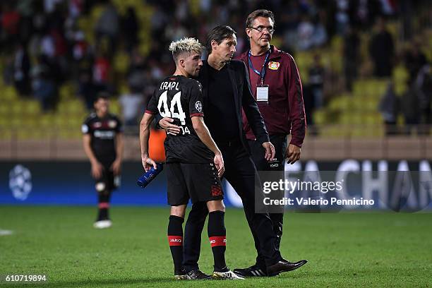 Bayer 04 Leverkusen head coach Roger Schmidt consoles Kevin Kampl at the end of the UEFA Champions League Group E match between AS Monaco FC and...