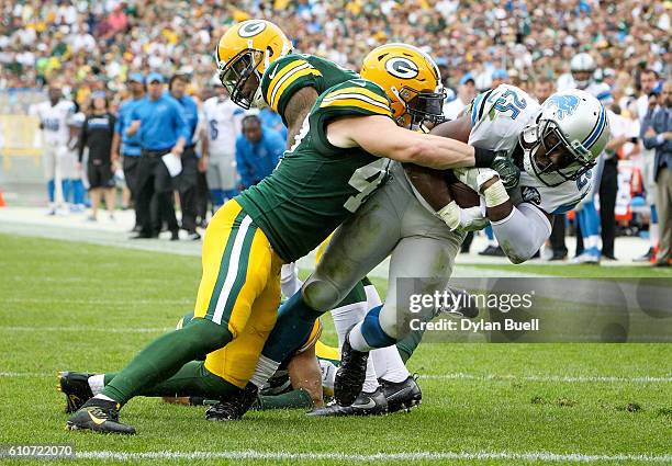 Jake Ryan of the Green Bay Packers tackles Theo Riddick of the Detroit Lions in the third quarter at Lambeau Field on September 25, 2016 in Green...