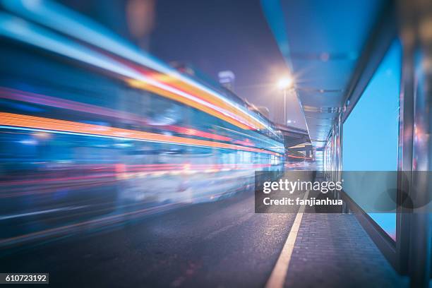 bus moving on street - windbreak stock pictures, royalty-free photos & images