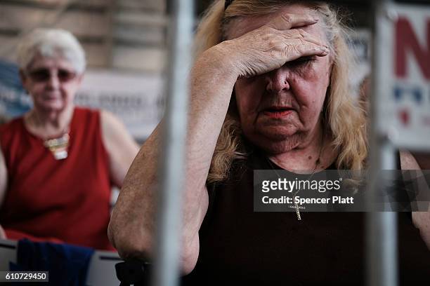 Donald Trump supporters pray as they attend a Trump rally the day after his first debate with Hillary Clinton on September 27, 2016 in Melbourne,...
