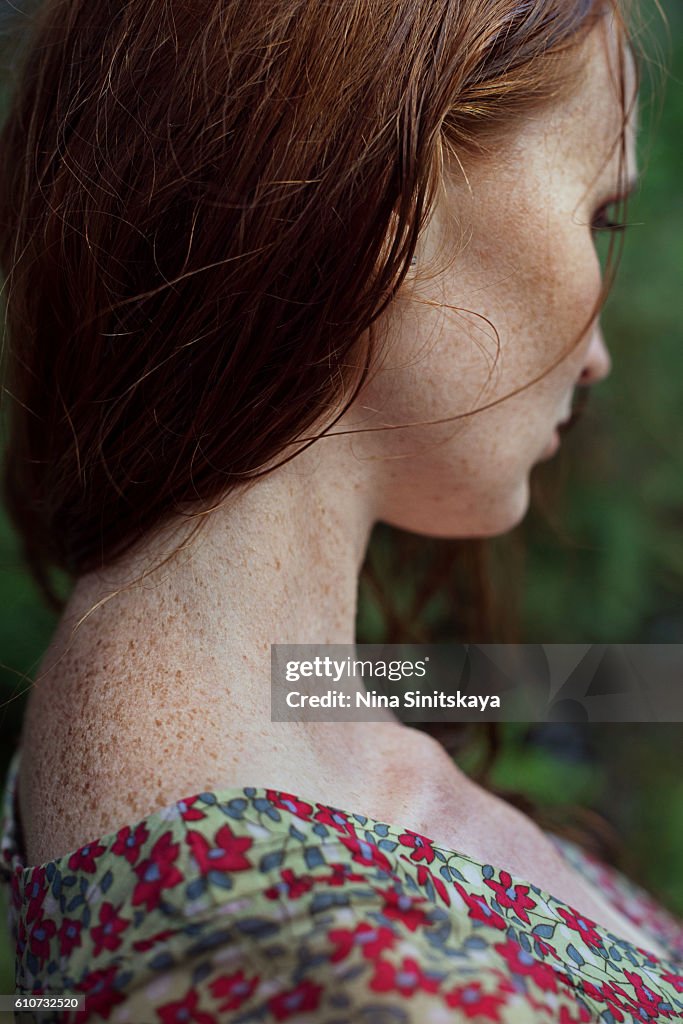 Profile of a red young woman with freckles