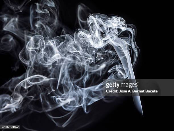 figures and forms of white smoke in movement on a black bottom - wispy stock pictures, royalty-free photos & images