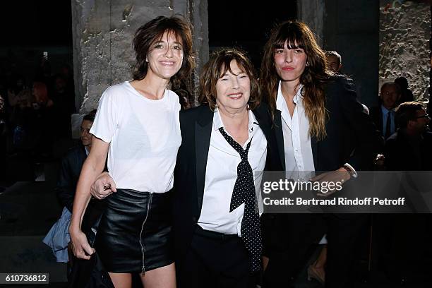 Jane Birkin standing between her daughters Charlotte Gainsbourg and Lou Doillon attend the Saint Laurent show as part of the Paris Fashion Week...