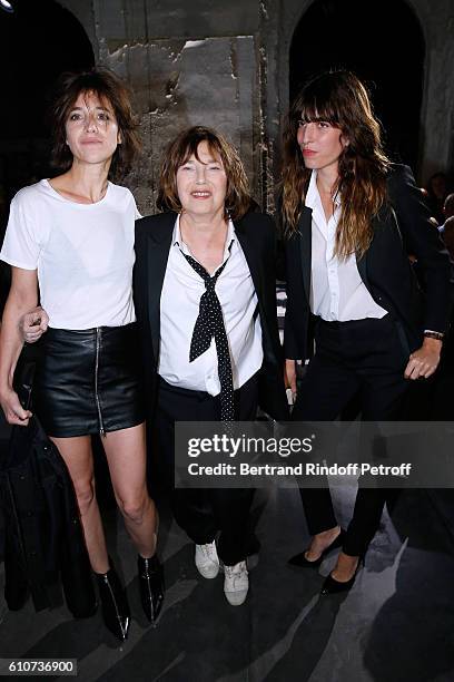 Jane Birkin standing between her daughters Charlotte Gainsbourg and Lou Doillon attend the Saint Laurent show as part of the Paris Fashion Week...