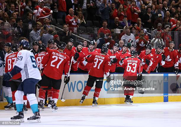 Brad Marchand of Team Canada high fives the bench after scoring a first period goal on Team Europe during Game One of the World Cup of Hockey final...