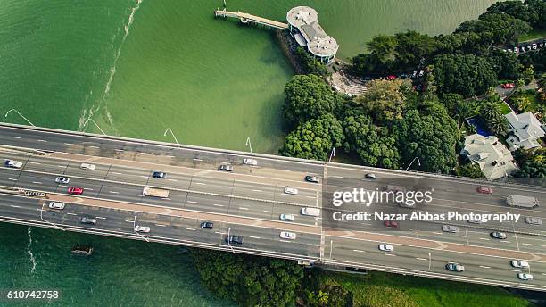 traffic on harbour bridge, auckland. - auckland aerial stock pictures, royalty-free photos & images