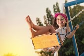 Little Girl Swinging At Sun Set