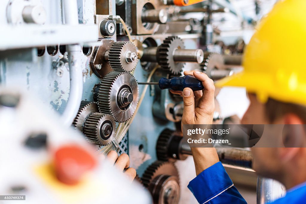Machinist precisely setting up cog wheels