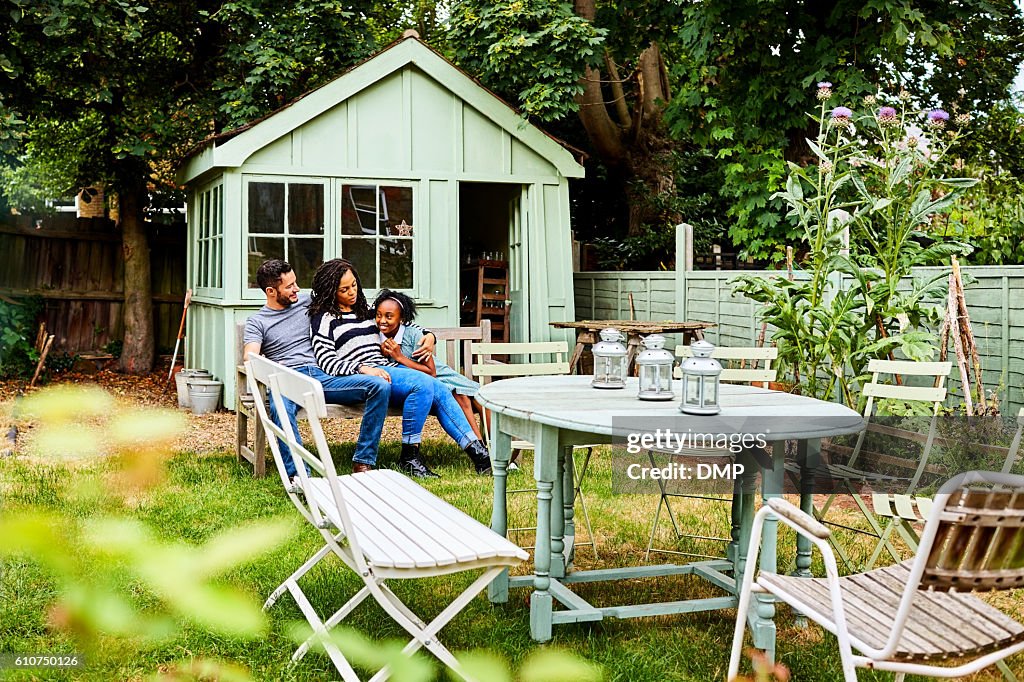 Transgender family sitting together in backyard