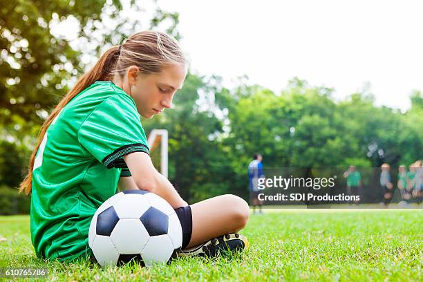 sad teenage girl after soccer game - nederlaag stockfoto's en -beelden