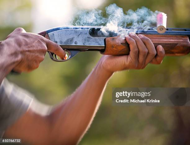 shotgun fired and shell expelled - tiro ao alvo imagens e fotografias de stock