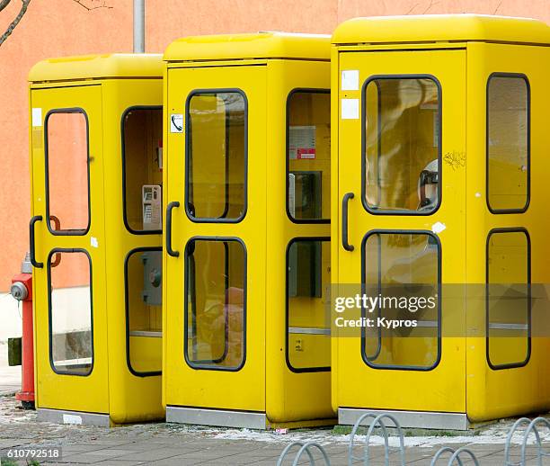 europe, germany, bavaria, view of row of yellow telephone booths - telefonzelle stock-fotos und bilder