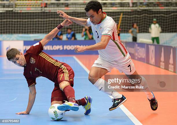 Ivan Milovanov of Russia fights for the ball with Ali Hassan Zadeh of Iran during a semi final match between Iran and Russia as part of 2016 FIFA...