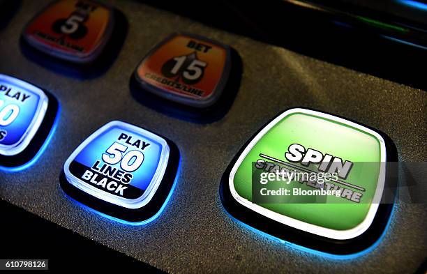 Buttons sit on a panel on a poker machine in the gaming room at the Vikings Club in Canberra, Australia, on Monday, Sept. 26, 2016. Despite having...