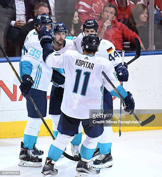 Tomas Tatar celebrates with Roman Josi, Anze Kopitar and Dennis Seidenberg of Team Europe after scoring a second period goal on Team Canada during...