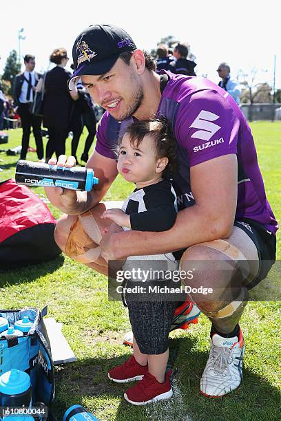 Jordan McLean of the Storm gives his son Archie a drink during a Melbourne Storm NRL training session at Gosch's Paddock on September 28, 2016 in...