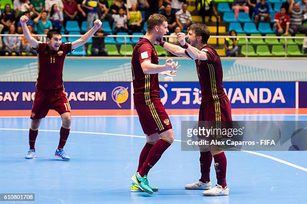 Artem Niiazov , Sergei Abramovich and Danil Davydov of Russia celebrate at the end of the FIFA Futsal World Cup Semi-Final match between Iran and...