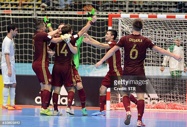 Russia's team players celebrate their victory over Iran during their Colombia 2016 FIFA Futsal World Cup semifinal match in Medellin, Colombia on...