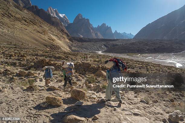 porters toward to baltoro glacier, k2trek - trango towers stock pictures, royalty-free photos & images
