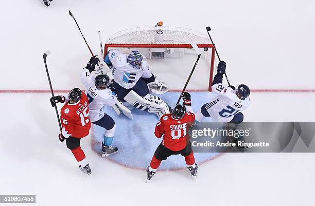 Jaroslav Halak, Mark Streit and Tomas Tatar of Team Europe clear a rebound against Ryan Getzlaf and Steven Stamkos of Team Canada during Game One of...