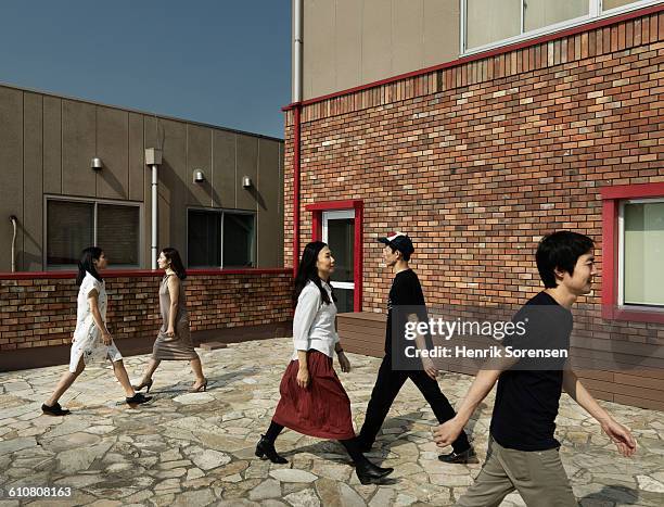 five young people passing each other - rasthof stock-fotos und bilder