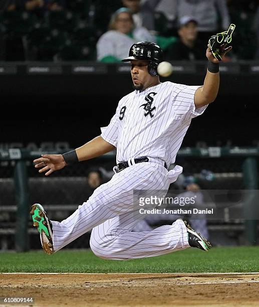 Jose Abreu of the Chicago White Sox beats the throw to score a run in the 8th inning against the Tampa Bay Rays at U.S. Cellular Field on September...