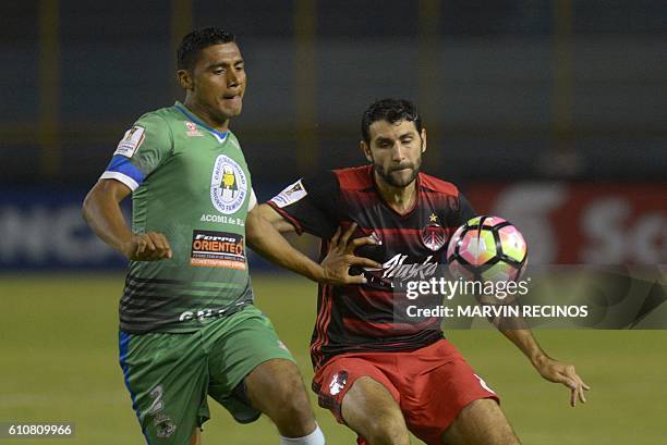 Luis Hernandez of Salvadorean team C. D. Dragon fights for the ball with Diego Valeri of Portland Timbers during a CONCACAF Champions League football...