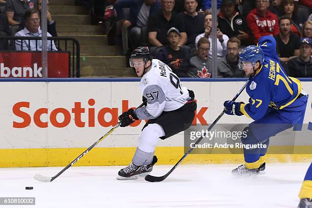 Joe Thornton of Team Canada stickhandles the puck with Victor Hedman of Team Sweden chasing during the World Cup of Hockey 2016 at Air Canada Centre...