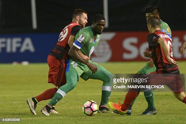 Jamal Jack of Salvadorean team C. D. Dragon fights for the ball with Jack Mcinerney of Portland Timbers during a CONCACAF Champions League football...