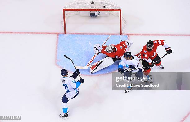 Tomas Tatar of Team Europe scores a goal on Carey Price of Team Canada as Marian Hossa of Team Europe battles with Brent Burns of Team Canada during...