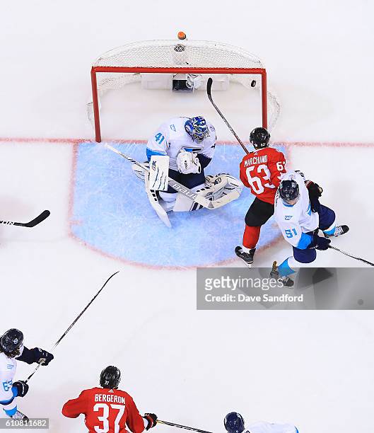 Patrice Bergeron of Team Canada scores on Jaroslav Halak of Team Europe as Brad Marchand of Team Canada battles with Frans Nielsen of Team Europe...