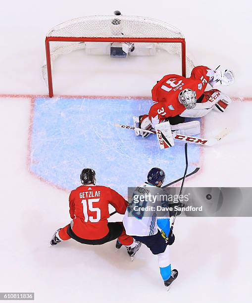 Carey Price of Team Canada makes a save against Leon Draisaitl of Team Europe as Ryan Getzlaf of Team Canada defends during Game One of the World Cup...