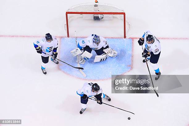 Anze Kopitar of Team Europe clears the puck from the crease as Jaroslav Halak of Team Europe, Zdeno Chara of Team Europe and Andrej Sekera of Team...