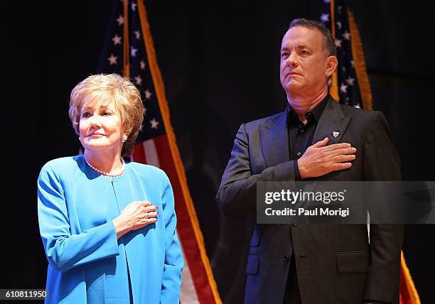 Sen. Elizabeth Dole and Tom Hanks stand at attendion during the singing of the U.S. National Anthem at the launch of the Elizabeth Dole Foundation's...