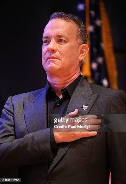 Campaign Chair Tom Hanks puts his hand on his heart during the singing of the U.S. National Anthem at the launch of the Elizabeth Dole Foundation's...