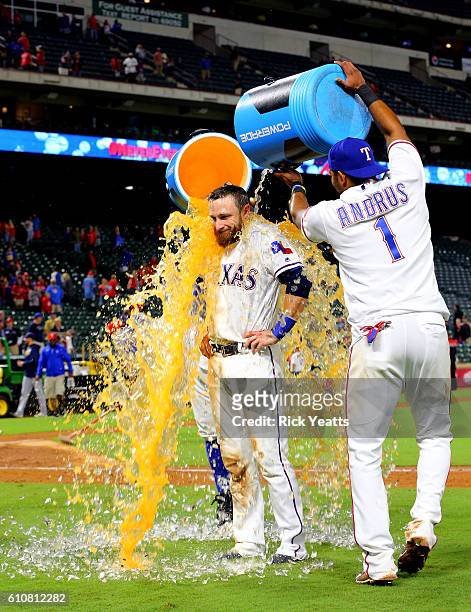 Elvis Andrus of the Texas Rangers dumps the cooler on Jonathan Lucroy at the end of the game against the Milwaukee Brewers at Globe Life Park in...