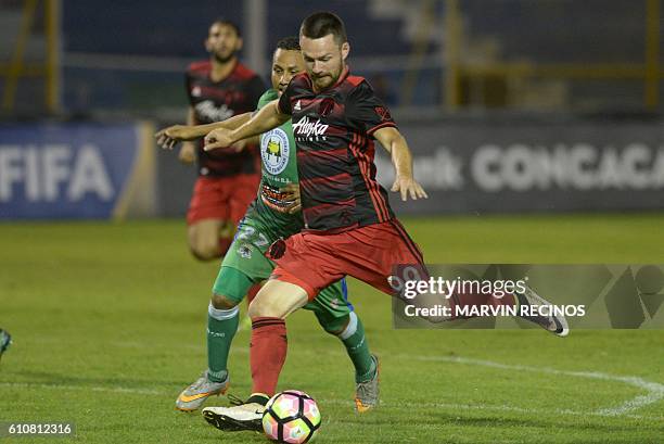 Edwin Benitez of Salvadorean team C. D. Dragon fights for the ball with Jack Mcinerney of Portland Timbers during a CONCACAF Champions League...