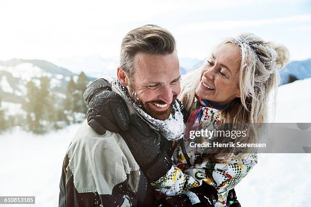 young couple on winter holiday - women winter snow stock-fotos und bilder