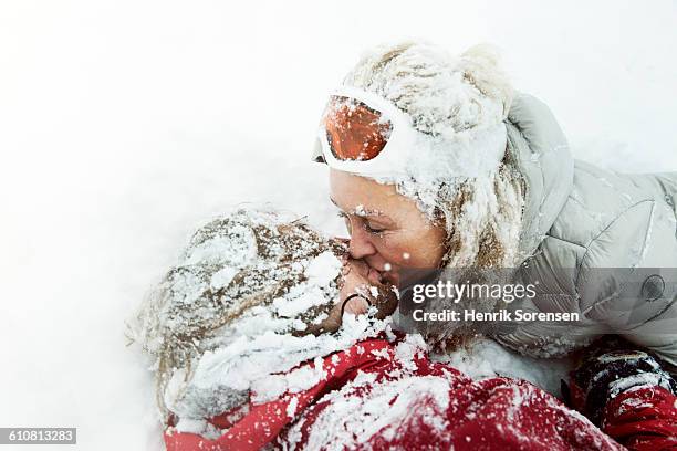 young couple kissing in the snow