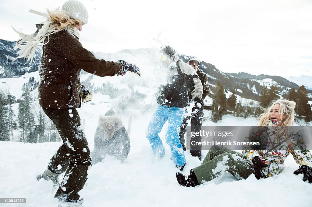 Young people on winter holiday, snowfight