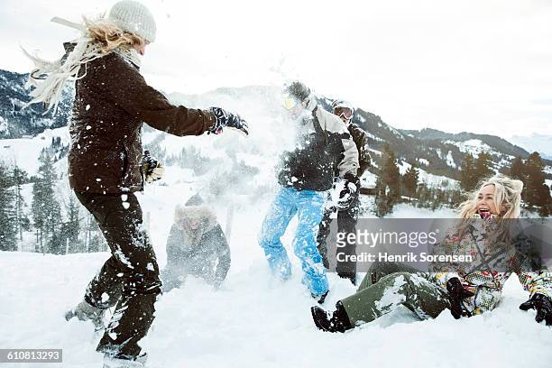 young people on winter holiday, snowfight - bola de neve imagens e fotografias de stock