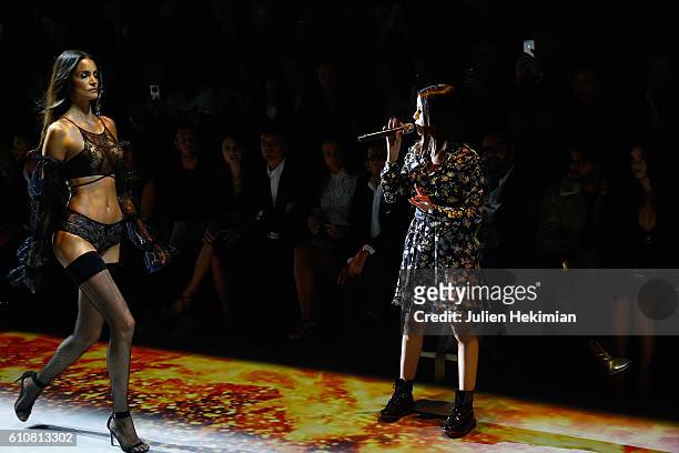 French Singer Marina Kaye performs on the catwalk during the Etam show as part of the Paris Fashion Week Womenswear Spring/Summer 2017 on September...