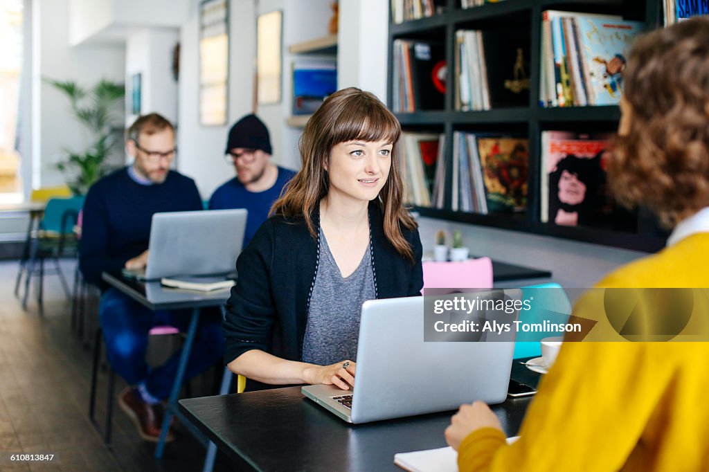 Young woman in cafe with laptop.