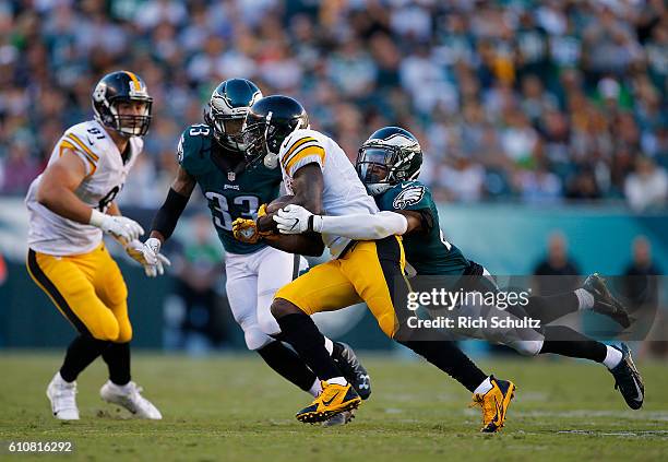 Markus Wheaton of the Pittsburgh Steelers is tackled by Rodney McLeod of the Philadelphia Eagles as Ron Brooks of the Eagles closes in during a game...